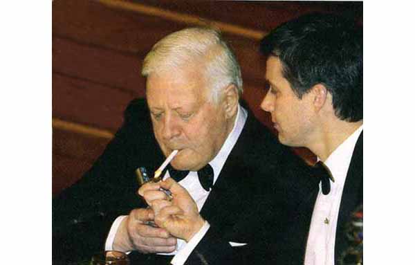 Prince Frederik of Denmark lighting the cigarette of Helmut Schmidt